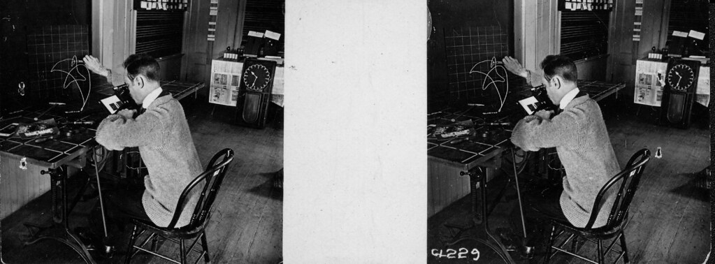 A man building wire models of work motions in Gilbreth's laboratory