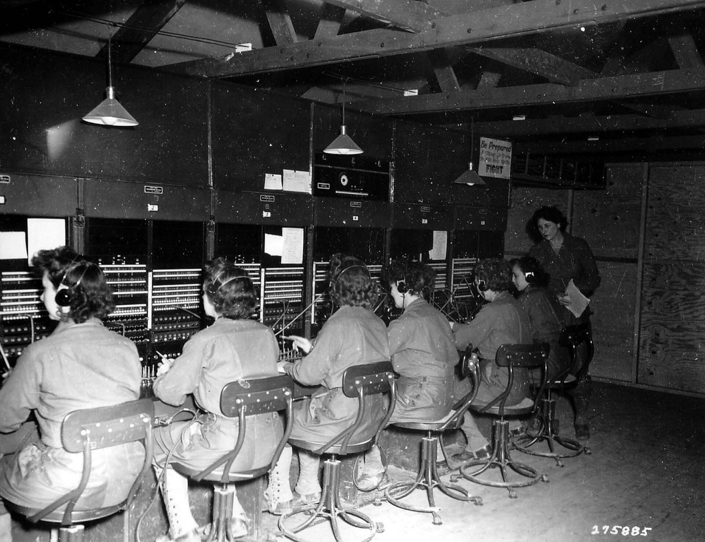 A row of telephone switchboard operators at work in the 1940s